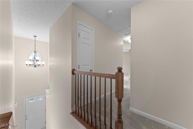 184 Creekledge Ln, Copley, OH 44321 - stairway with carpet flooring, a chandelier, and a textured ceiling
