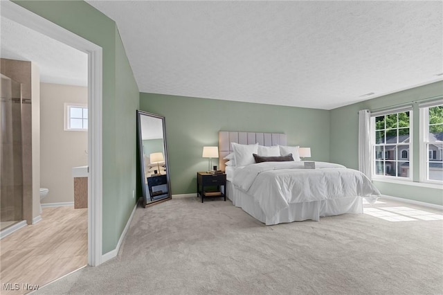 184 Creekledge Ln, Copley, OH 44321 - carpeted bedroom with a textured ceiling and ensuite bathroom