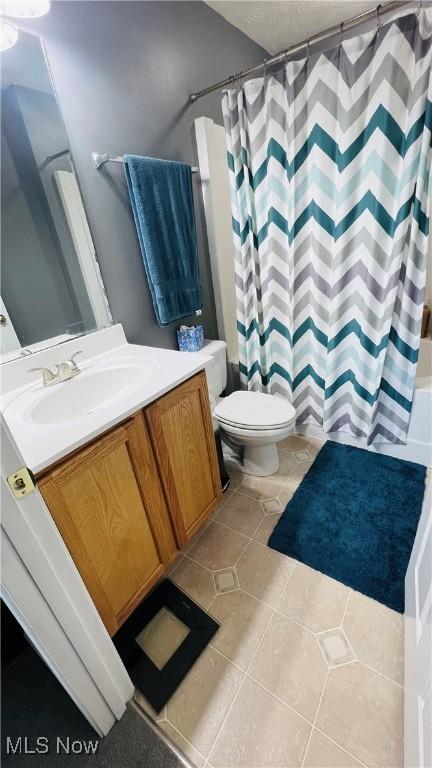 116 Ledgestone Ct, Berea, OH 44017 - bathroom with vanity, tile patterned floors, and shower / bath combo with shower curtain