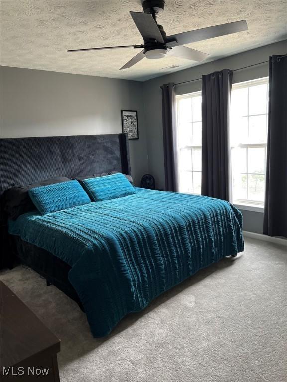 116 Ledgestone Ct, Berea, OH 44017 - carpeted bedroom featuring a textured ceiling and a ceiling fan