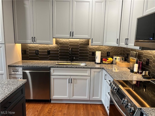 116 Ledgestone Ct, Berea, OH 44017 - kitchen with appliances with stainless steel finishes, decorative backsplash, stone counters, and white cabinets