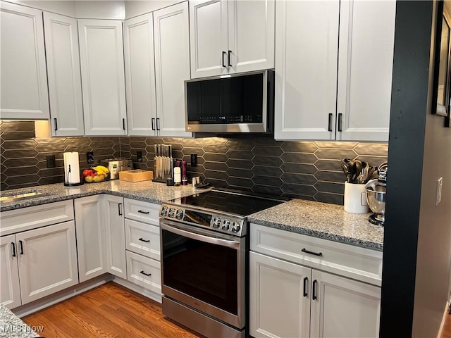 116 Ledgestone Ct, Berea, OH 44017 - kitchen featuring appliances with stainless steel finishes, white cabinetry, and decorative backsplash