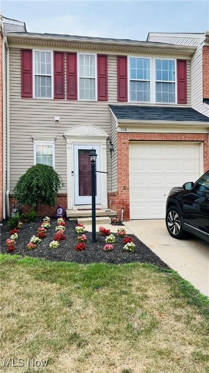 116 Ledgestone Ct, Berea, OH 44017 - view of front of property with an attached garage, brick siding, and a front yard