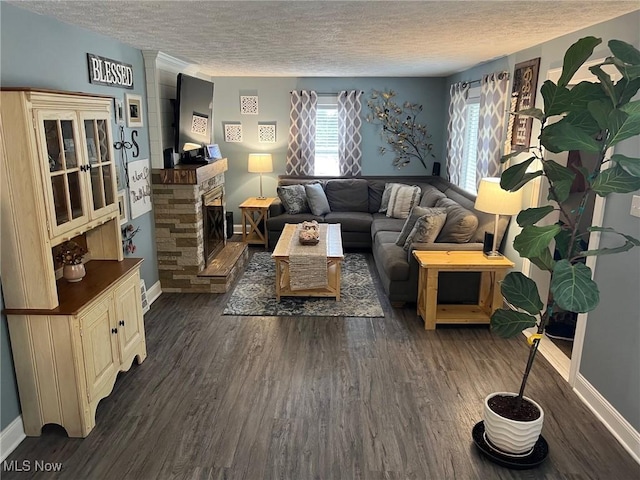 4575 Fishcreek Rd, Stow, OH 44224 - living room featuring a textured ceiling, dark wood-style flooring, and a stone fireplace