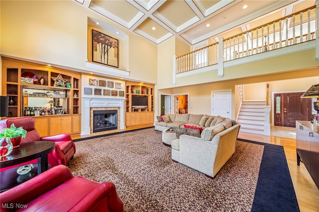11275 Beechnut Ln, Chardon, OH 44024 - living area with a high ceiling, a tiled fireplace, coffered ceiling, stairs, and beamed ceiling