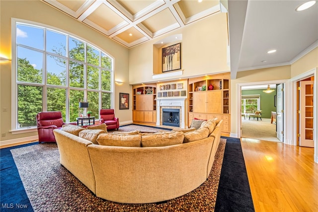 11275 Beechnut Ln, Chardon, OH 44024 - living room featuring a towering ceiling, wood finished floors, a fireplace, ornamental molding, and coffered ceiling