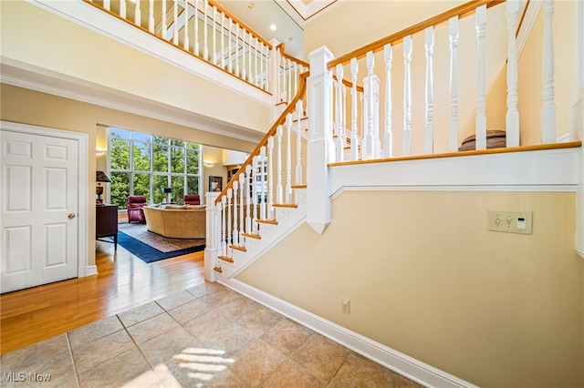 11275 Beechnut Ln, Chardon, OH 44024 - tiled foyer featuring a high ceiling, stairway, and ornamental molding