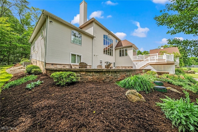 11275 Beechnut Ln, Chardon, OH 44024 - rear view of property with a deck, stairway, and a chimney
