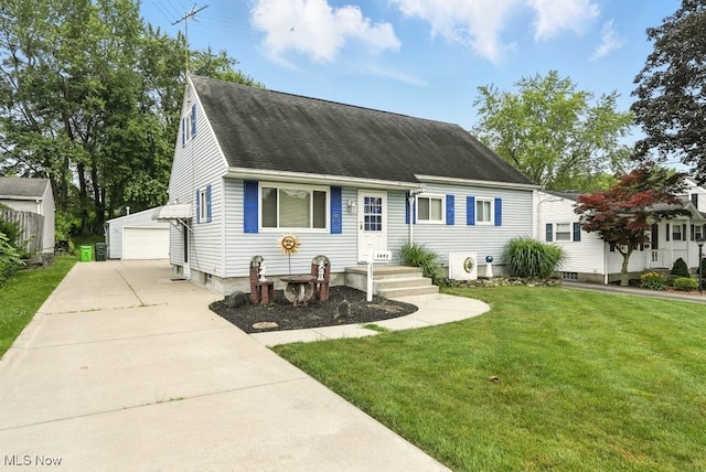 3692 Orchard St, Mogadore, OH 44260 - cape cod home featuring an outbuilding, a garage, roof with shingles, and a front yard