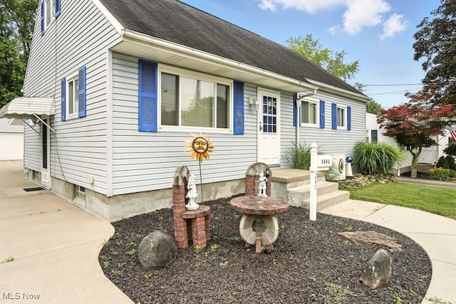 3692 Orchard St, Mogadore, OH 44260 - view of front of house featuring a garage and roof with shingles