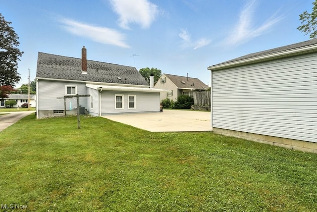 3692 Orchard St, Mogadore, OH 44260 - back of property with a patio, a lawn, and a chimney