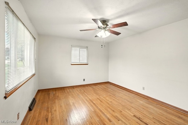 3692 Orchard St, Mogadore, OH 44260 - empty room with ceiling fan, light wood-style floors, and a baseboard radiator