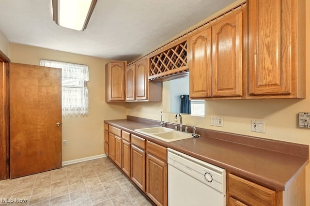 3692 Orchard St, Mogadore, OH 44260 - kitchen with white dishwasher, plenty of natural light, and brown cabinets