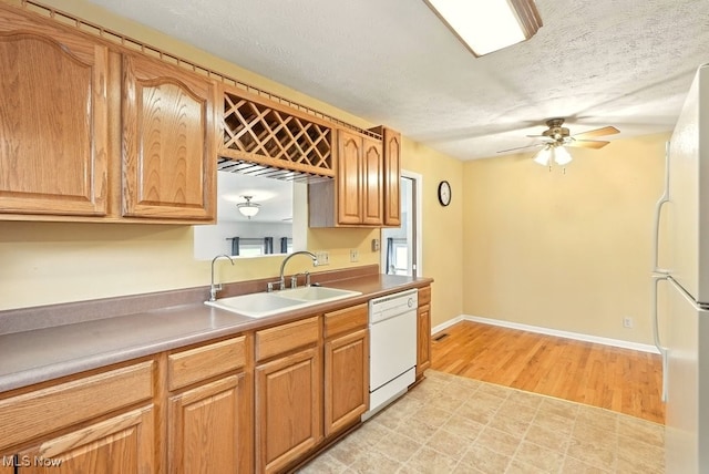 3692 Orchard St, Mogadore, OH 44260 - kitchen with white appliances, a ceiling fan, a textured ceiling, light wood finished floors, and light countertops