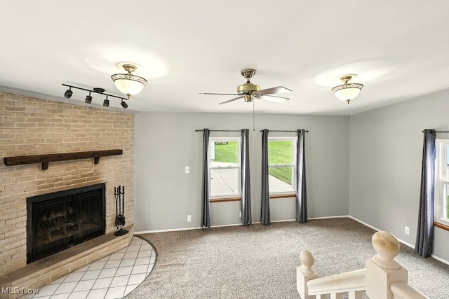 3692 Orchard St, Mogadore, OH 44260 - unfurnished living room featuring ceiling fan, a brick fireplace, light carpet, and rail lighting