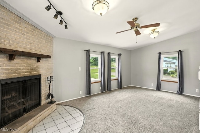 3692 Orchard St, Mogadore, OH 44260 - unfurnished living room with carpet, a fireplace, ceiling fan, and rail lighting