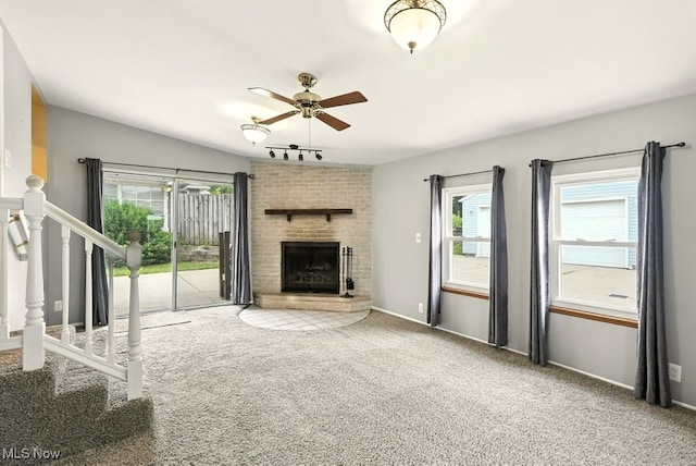 3692 Orchard St, Mogadore, OH 44260 - unfurnished living room featuring ceiling fan, a fireplace, carpet floors, and plenty of natural light