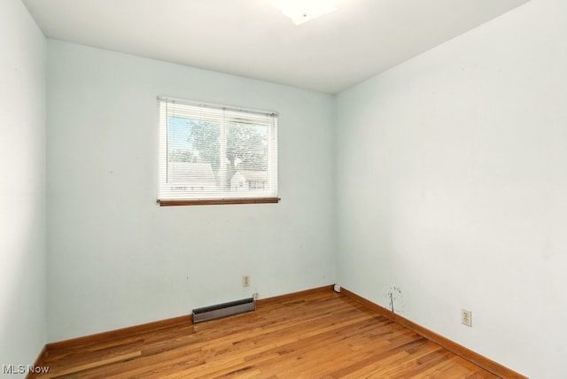3692 Orchard St, Mogadore, OH 44260 - spare room with a baseboard heating unit and light wood-style floors