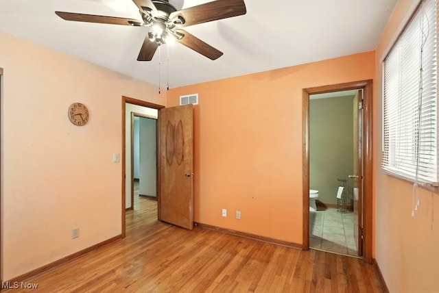 3692 Orchard St, Mogadore, OH 44260 - unfurnished bedroom with light wood-style flooring, ensuite bathroom, and ceiling fan