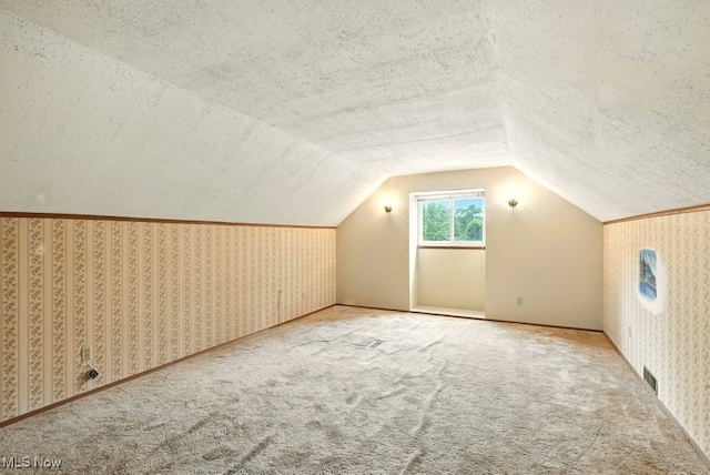3692 Orchard St, Mogadore, OH 44260 - bonus room with wallpapered walls, lofted ceiling, carpet, and a textured ceiling