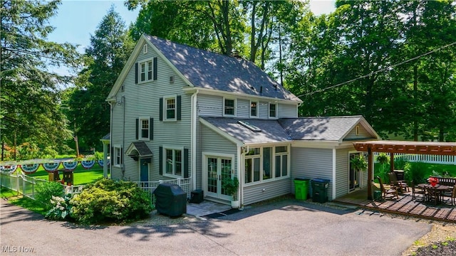 6735 Wakefield Rd, Hiram, OH 44234 - back of property featuring a patio area and a shingled roof