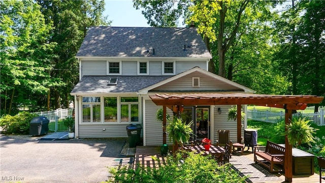 6735 Wakefield Rd, Hiram, OH 44234 - rear view of property featuring roof with shingles and a patio