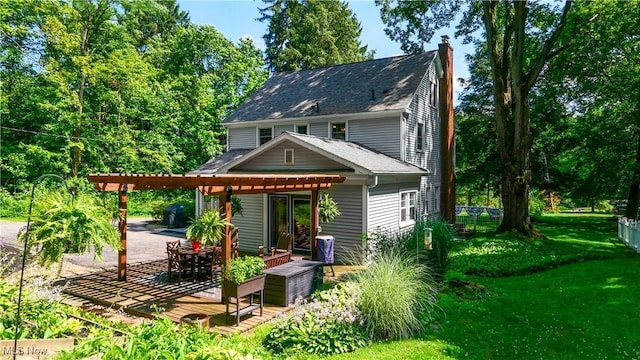 6735 Wakefield Rd, Hiram, OH 44234 - back of property with a chimney, a wooden deck, a shingled roof, a carport, and a pergola