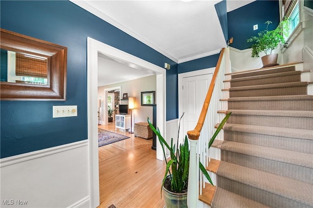 6735 Wakefield Rd, Hiram, OH 44234 - stairs with wainscoting, wood finished floors, and ornamental molding