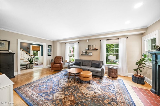 6735 Wakefield Rd, Hiram, OH 44234 - living area featuring stairway, light wood-style flooring, crown molding, and a fireplace with flush hearth