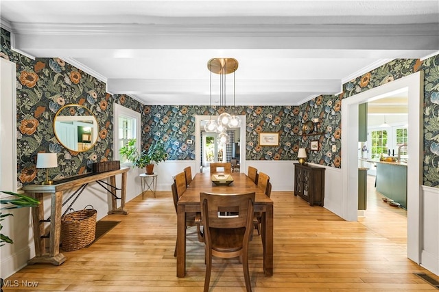 6735 Wakefield Rd, Hiram, OH 44234 - dining room featuring wallpapered walls, wainscoting, light wood-style floors, a chandelier, and crown molding