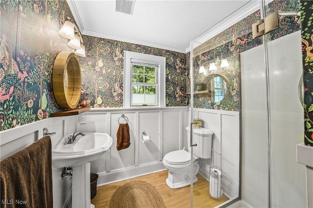 6735 Wakefield Rd, Hiram, OH 44234 - bathroom with ornamental molding, wallpapered walls, a decorative wall, wood finished floors, and wainscoting