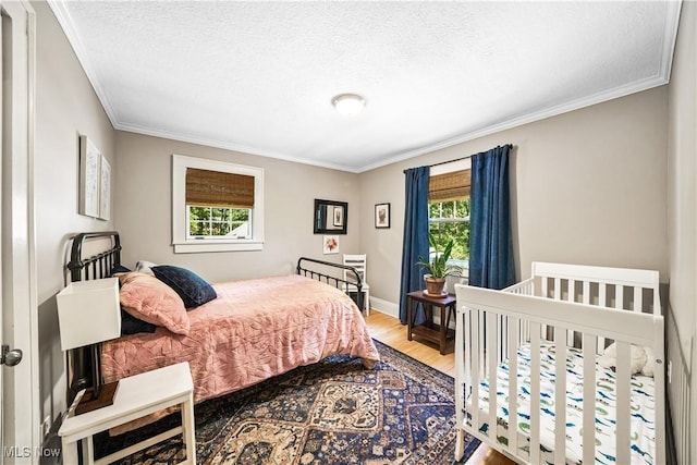 6735 Wakefield Rd, Hiram, OH 44234 - bedroom featuring wood finished floors, ornamental molding, and a textured ceiling