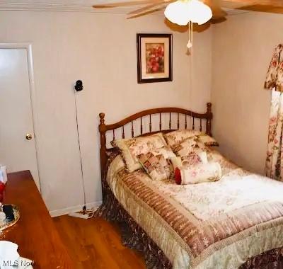 134 E Summit St, Alliance, OH 44601 - bedroom with wood finished floors, ceiling fan, and crown molding