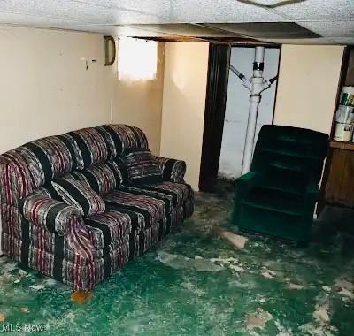 134 E Summit St, Alliance, OH 44601 - living room with unfinished concrete flooring