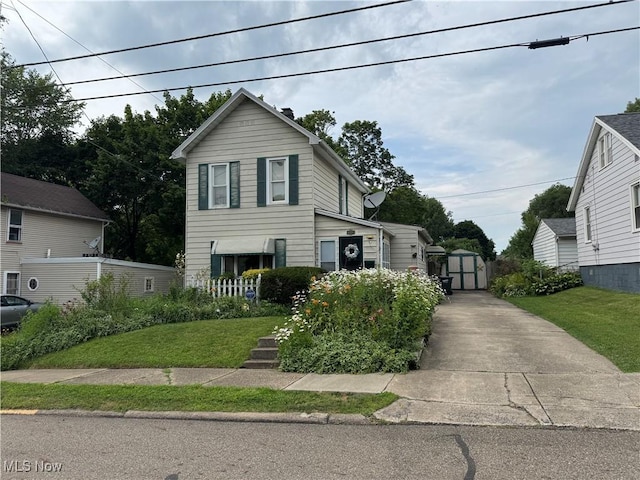 134 E Summit St, Alliance, OH 44601 - traditional-style home featuring a shed and a front yard