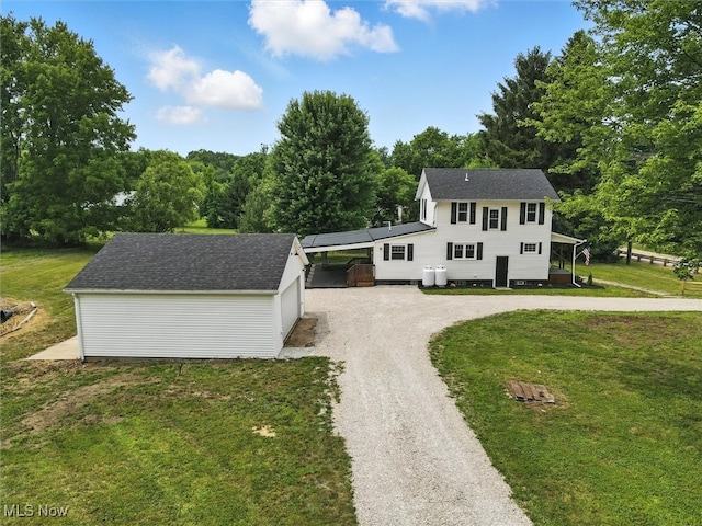4930 S Ridge Rd W, Ashtabula, OH 44004 - view of front of property featuring curved driveway, an outbuilding, and a front lawn