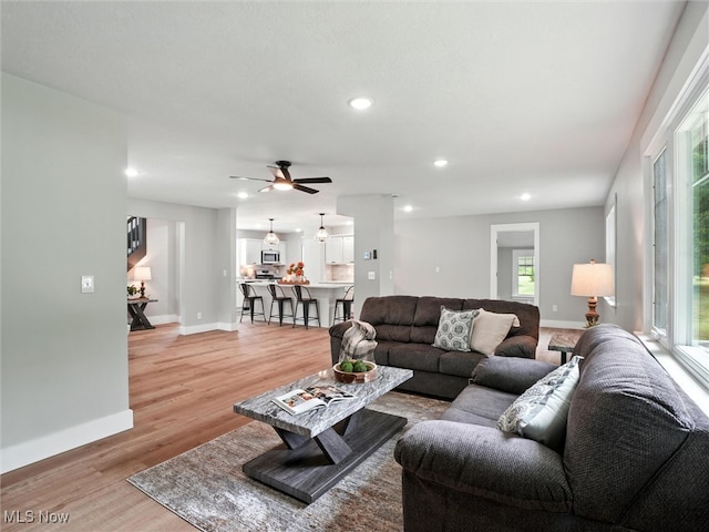 4930 S Ridge Rd W, Ashtabula, OH 44004 - living room featuring light wood-type flooring, healthy amount of natural light, ceiling fan, and recessed lighting