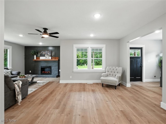 4930 S Ridge Rd W, Ashtabula, OH 44004 - living room with light wood-style floors, a glass covered fireplace, a ceiling fan, and recessed lighting