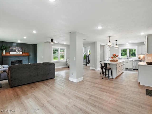 4930 S Ridge Rd W, Ashtabula, OH 44004 - living room featuring recessed lighting, healthy amount of natural light, light wood-type flooring, ceiling fan, and a fireplace