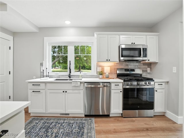 4930 S Ridge Rd W, Ashtabula, OH 44004 - kitchen featuring stainless steel appliances, tasteful backsplash, light wood-style flooring, light countertops, and recessed lighting
