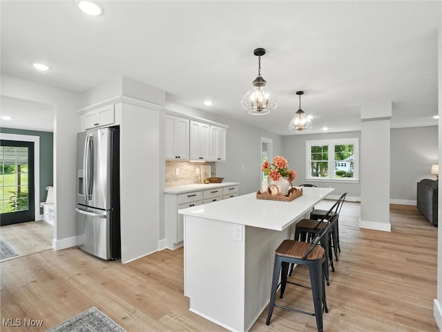 4930 S Ridge Rd W, Ashtabula, OH 44004 - kitchen with stainless steel fridge with ice dispenser, white cabinetry, light countertops, light wood-style flooring, and recessed lighting