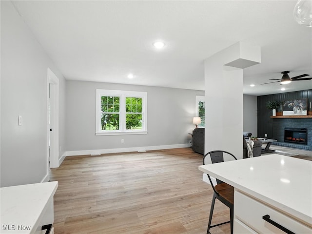 4930 S Ridge Rd W, Ashtabula, OH 44004 - kitchen with open floor plan, a fireplace, light wood-type flooring, a ceiling fan, and recessed lighting