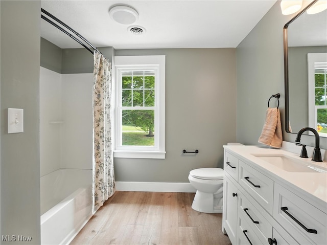 4930 S Ridge Rd W, Ashtabula, OH 44004 - bathroom featuring healthy amount of natural light, vanity, wood finished floors, and shower / bathtub combination with curtain