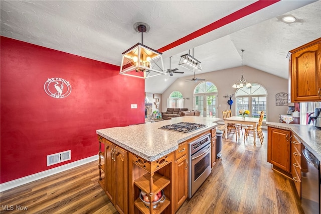1743 Silver St, Wickliffe, OH 44092 - kitchen with appliances with stainless steel finishes, ceiling fan, vaulted ceiling, dark wood-type flooring, and brown cabinets