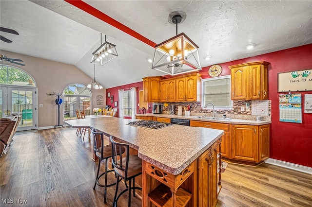 1743 Silver St, Wickliffe, OH 44092 - kitchen featuring wood finished floors, brown cabinetry, a ceiling fan, lofted ceiling, and a textured ceiling