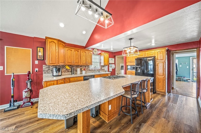 1743 Silver St, Wickliffe, OH 44092 - kitchen with a chandelier, stainless steel appliances, dark wood-type flooring, brown cabinetry, and vaulted ceiling