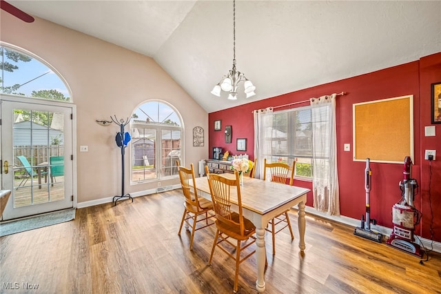 1743 Silver St, Wickliffe, OH 44092 - dining room featuring wood finished floors, a chandelier, plenty of natural light, and high vaulted ceiling