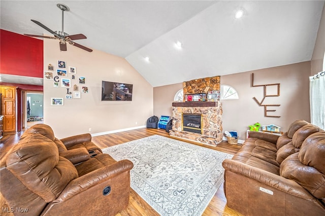 1743 Silver St, Wickliffe, OH 44092 - living room featuring ceiling fan, lofted ceiling, wood finished floors, and a stone fireplace