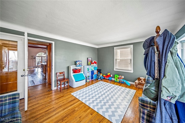 1743 Silver St, Wickliffe, OH 44092 - rec room with wood finished floors and a textured ceiling