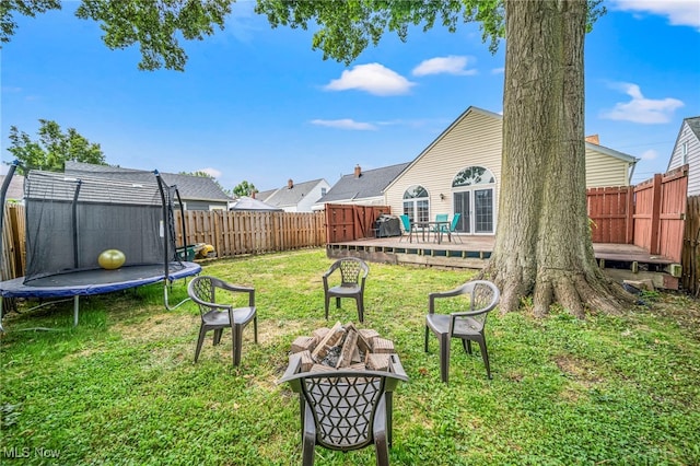 1743 Silver St, Wickliffe, OH 44092 - fenced backyard with a trampoline, a fire pit, and a wooden deck